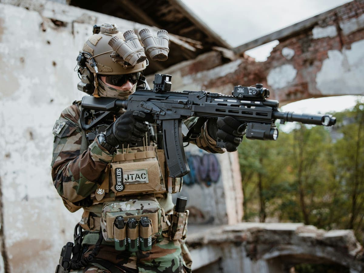 A shooter wearing quad tube night vision goggles