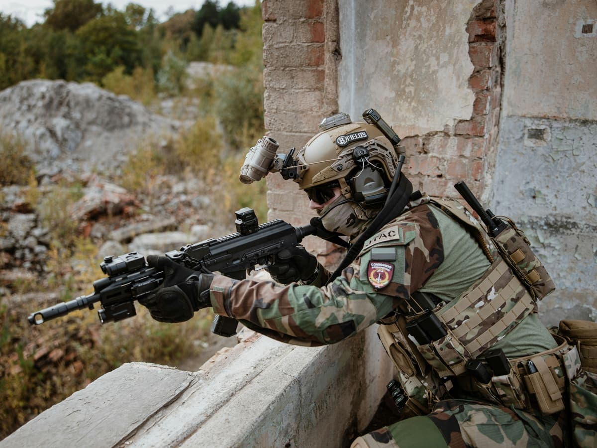 A shooter sighting a rifle fitted with an optic