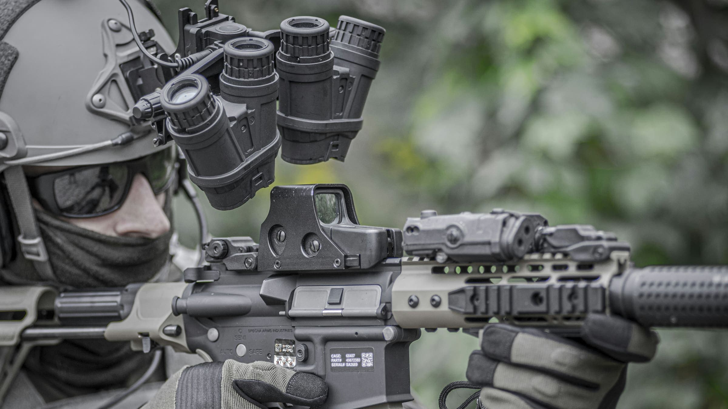 An operator shouldering a rifle at dusk